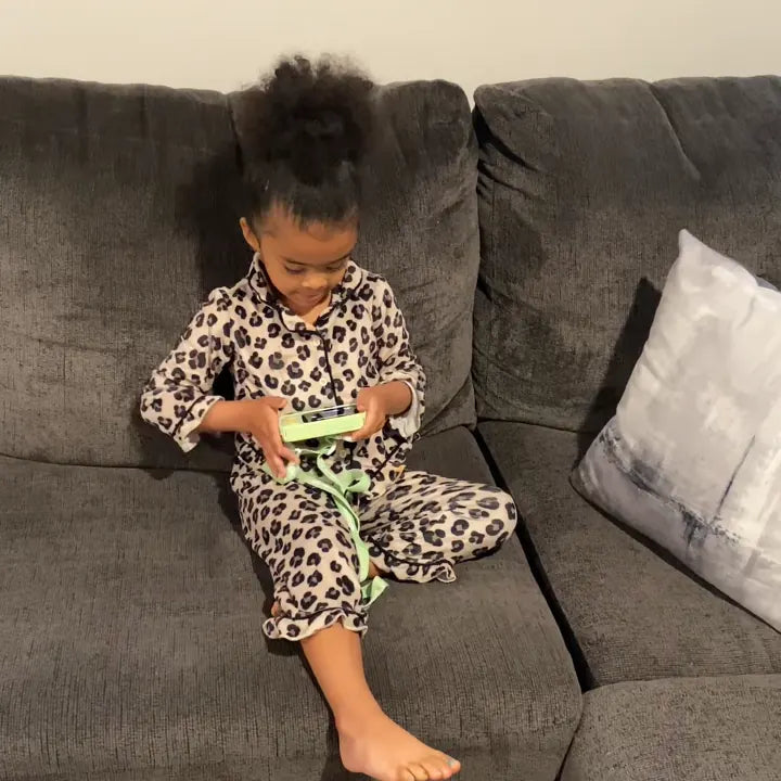Child learning with Dr.Look AI Cap on the couch