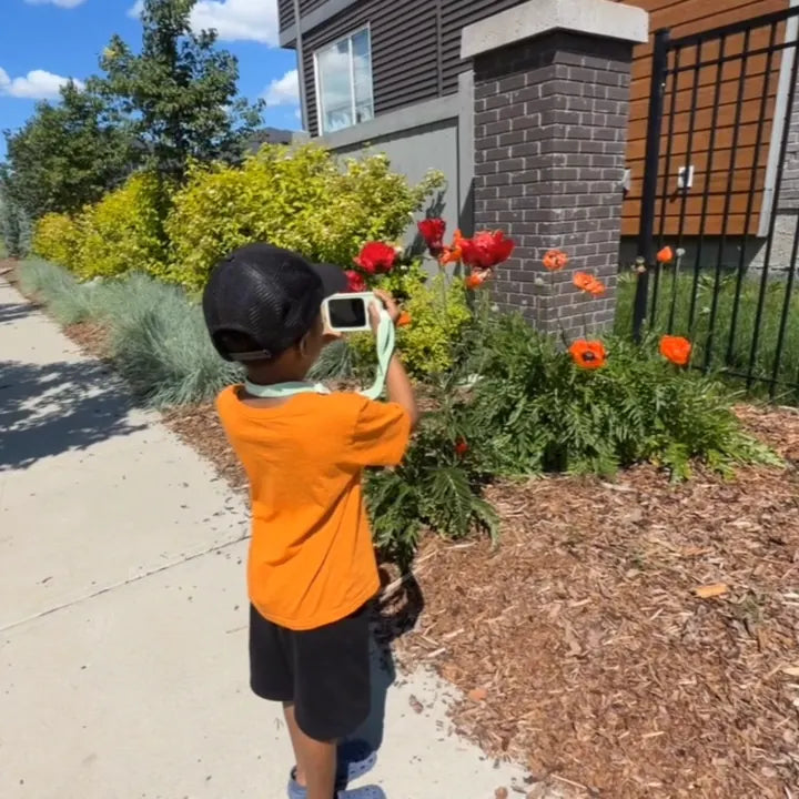 Child using Dr.Look AI Cap to identify flowers outdoors
